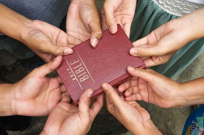 133452947 featured image Bible held by many people