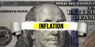Inflation written behind a banknote