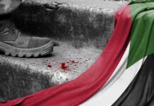 A boot next to blood and the Palestinian flag
