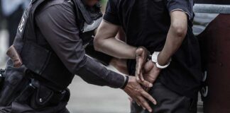 Man arrested and handcuffed