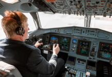 Pilot in cockpit operating airplane controls