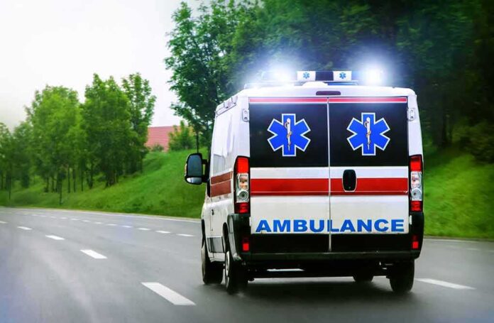 791317669 featured image Ambulance driving on a paved road with lights flashing