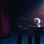 Microphone resting on a stool on stage