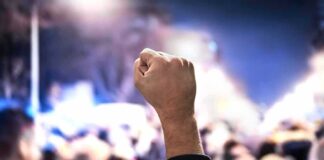 protest Raised fist in a crowd at night