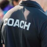 Person wearing a shirt labeled Coach