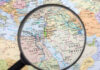 Magnifying glass over Middle East map highlighting Israel and Egypt