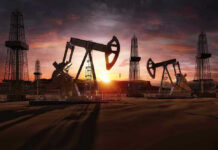 Oil rigs operating at sunset in a desert landscape