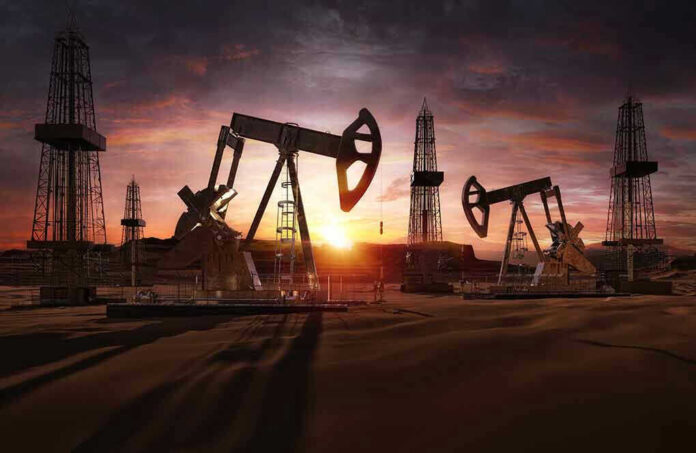 Oil rigs operating at sunset in a desert landscape