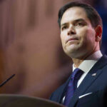 Man in suit speaking at podium
