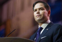 Man in suit speaking at podium