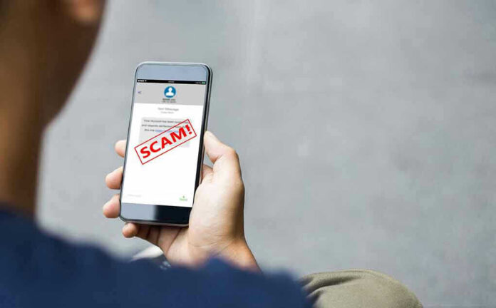 2058303887 Person reading a scam message on a smartphone
