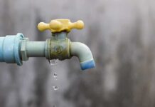 Close-up of a dripping outdoor water faucet