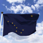 Alaska Preparing For Possible Catastrophic Flooding Alaska state flag flying against a blue sky