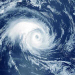 TERRIFYING Hurricane Season Prediction Coming True Satellite image of a swirling hurricane over ocean.