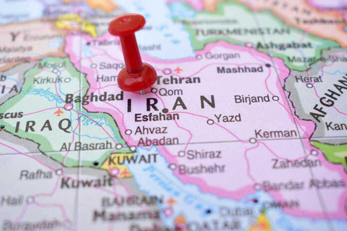 Red pushpin marking Iran on a map