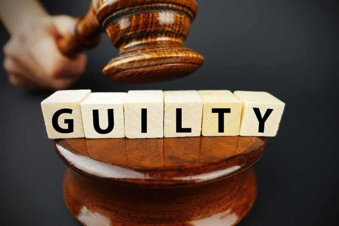A gavel striking down next to wooden blocks spelling GUILTY