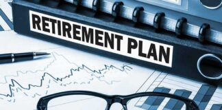 Close-up of a retirement plan binder with glasses and financial charts