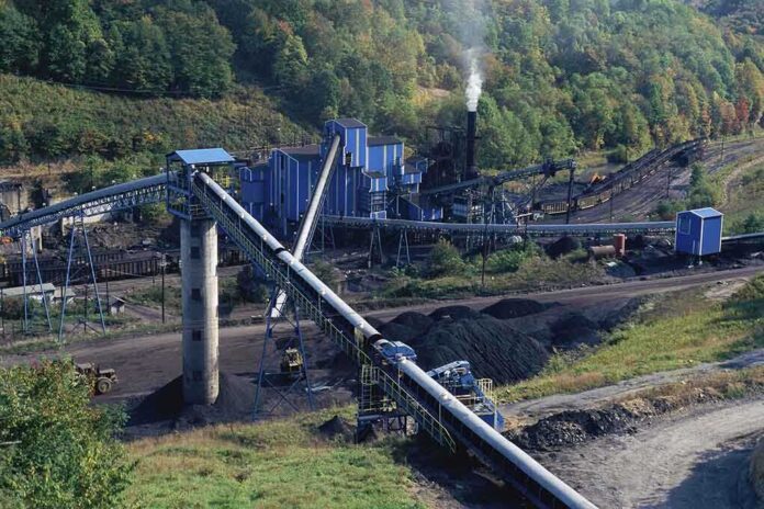 Industrial coal processing facility with conveyor belts and smoke stack