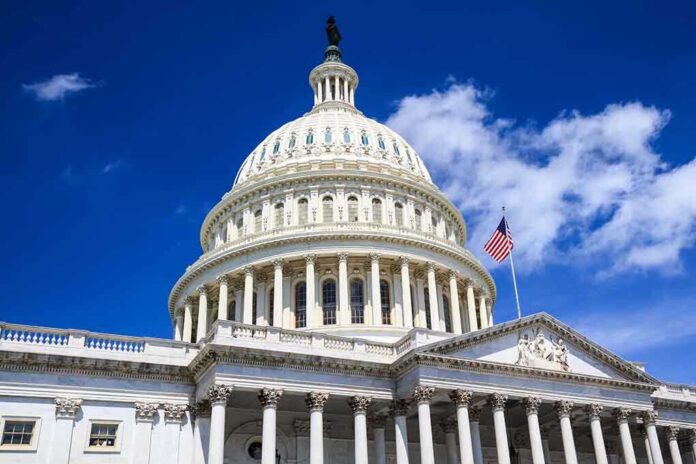 The U.S. Capitol building with a dome and American flag against a blue sky
