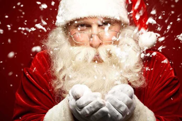 Santa Claus blowing snowflakes with a joyful expression