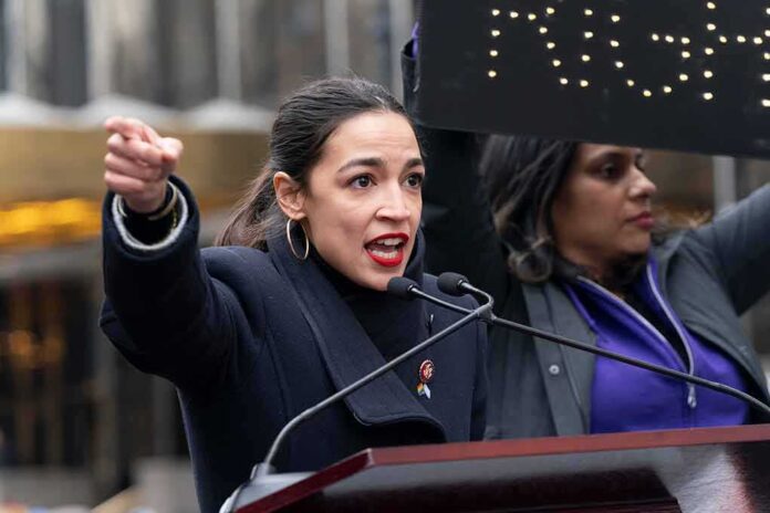 A woman passionately speaking at a rally with a sign in the background