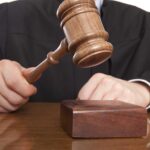 Judge Rips Veil Off During Kirk Courtroom Decision A judge holding a gavel above a wooden block