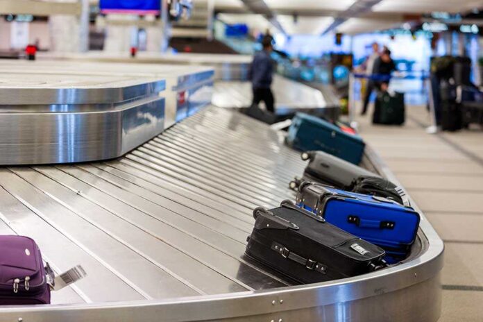 Luggage on a conveyor belt at an airport baggage claim area