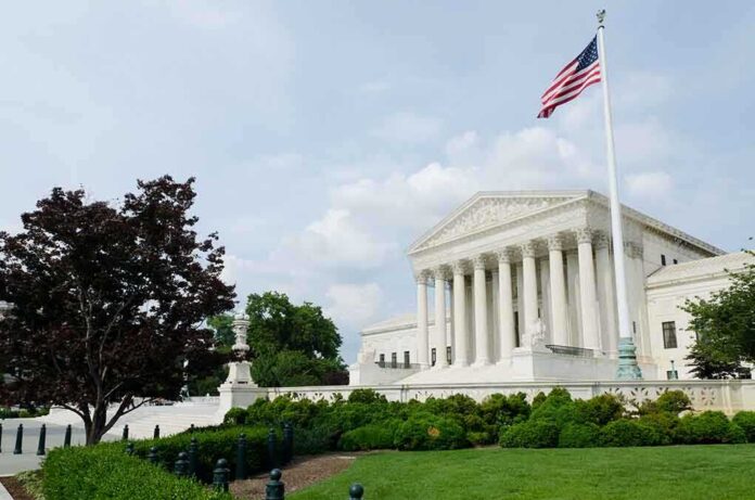 shutterstock_78346810.jpg The U.S. Supreme Court building with an American flag and landscaped grounds