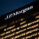 Illuminated J.P. Morgan building at night with visible office windows