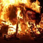 Inferno KILLS 40, Injures 119 – Shocking Cause Revealed! A large fire engulfing debris at night
