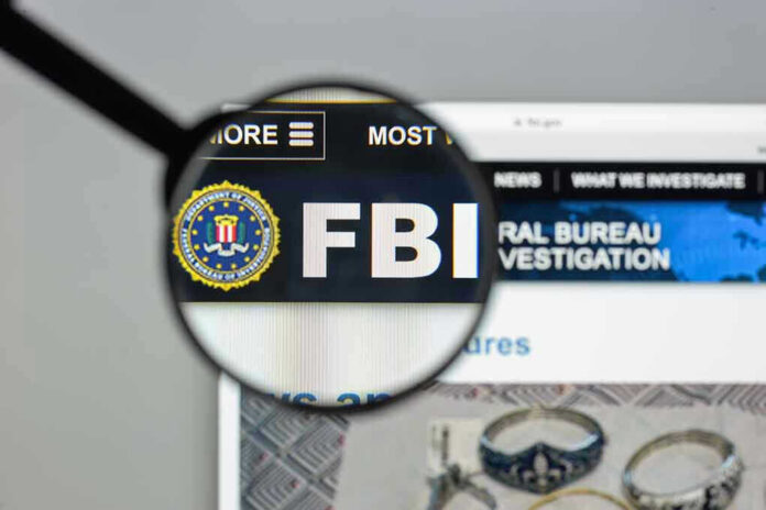 696480232 FBI website shown through magnifying glass.