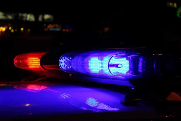 shutterstock_206223412.jpg Close-up of police lights flashing in blue and red at night