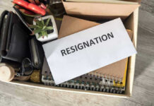 Woke Mayor Immediately Resigns Just Months After Swearing In Envelope labeled RESIGNATION atop office supplies in box.