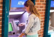 Young woman using an ATM in an urban environment