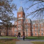 NCAA Black Athletes Caught In Political CROSSFIRE! Historic university building with students walking in front during autumn