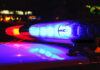 Police car lights flashing at night.