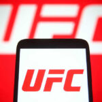 Patriotic Fighter Drops EPIC Statement During White House Event! UFC logo on phone screen and background.