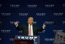 Man giving thumbs up at Trump Pence rally.