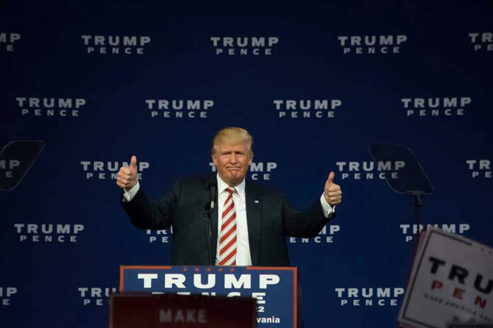 Man giving thumbs up at Trump Pence rally.