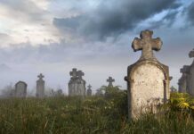 What They Did To Metcalf Graves Sparks National OUTRAGE! Foggy graveyard with tombstones and crosses under a cloudy sky