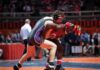 Wrestler Sexually Assaulted by Man Competing As a Woman! Two wrestlers competing on a mat during a match