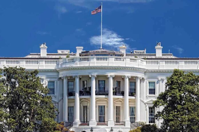 shutterstock_184005656 The White House with the American flag flying against a blue sky