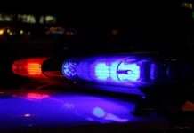 Warning ALERT as Children Recruited for Criminal Acts Surges! Close-up of police lights flashing in blue and red at night