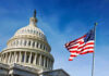 Trump BREAKS World Record – Midnight Chaos! U.S. Capitol building with American flag in foreground.