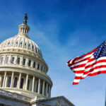 U.S. Capitol building with American flag in foreground.