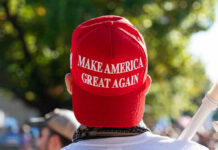 Boardwalk Brawl ERUPTS Over Trump Merch! Person wearing a red Make America Great Again hat.