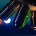 Closeup of microscope lenses with colorful background