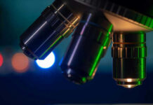Closeup of microscope lenses with colorful background