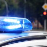 Gang Crossfire Kills Officer’s Son Police car blue siren light flashing