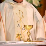 Priest Smoking Meth in Church Shocks Town A priest holding a golden chalice during a religious ceremony